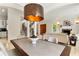 Elegant dining room featuring a modern table, stylish chandelier, and staircase at 1010 Terrace Blvd, Orlando, FL 32803