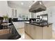 Modern kitchen with black countertops, white cabinets, and stainless steel appliances at 1010 Terrace Blvd, Orlando, FL 32803