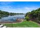 Scenic lake view from a backyard featuring a wooden dock and lush greenery, ideal for relaxation at 1010 Terrace Blvd, Orlando, FL 32803