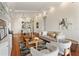Open-concept living room with stylish seating, hardwood floors, and seamless flow to dining area at 1010 Terrace Blvd, Orlando, FL 32803