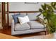 Comfortable sitting area with a stylish gray sofa and decorative pillows at 1010 Terrace Blvd, Orlando, FL 32803