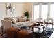 Bright living room with comfortable seating, decorative rug, and natural light from the balcony at 1010 Terrace Blvd, Orlando, FL 32803