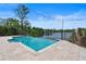 The backyard features a stunning swimming pool with waterfront views and beautifully landscaped surroundings, perfect for relaxation at 1010 Terrace Blvd, Orlando, FL 32803