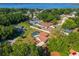 Aerial view of a home with a screened-in pool and a lake in the background surrounded by lush trees at 10545 Parkway Dr, Clermont, FL 34711
