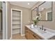 Bathroom features a modern vanity, dual mirrors, and built in shelving at 10545 Parkway Dr, Clermont, FL 34711