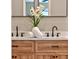 Bathroom showcasing double sinks, modern faucets, and a wood vanity at 10545 Parkway Dr, Clermont, FL 34711