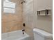 Bathroom featuring an updated shower and tiled walls at 10545 Parkway Dr, Clermont, FL 34711