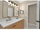 Bathroom with double sinks, modern fixtures, and a well-lit mirror at 10545 Parkway Dr, Clermont, FL 34711