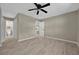 Spacious bedroom featuring tile floors, ceiling fan, and neutral paint at 10545 Parkway Dr, Clermont, FL 34711