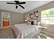 This cozy bedroom is enhanced by artwork and natural light to create a soothing space at 10545 Parkway Dr, Clermont, FL 34711