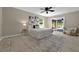 Cozy bedroom with a ceiling fan, a large rug, and sliding glass doors to the outside at 10545 Parkway Dr, Clermont, FL 34711
