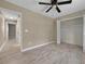 Cozy bedroom with a ceiling fan, tile floors, and closet at 10545 Parkway Dr, Clermont, FL 34711