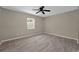 Large bedroom features tile floors, a ceiling fan and a window at 10545 Parkway Dr, Clermont, FL 34711