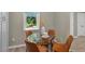 A glass dining table sits near a window, offering views and ample natural light at 10545 Parkway Dr, Clermont, FL 34711