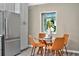 Eat-in kitchen features a stainless steel refrigerator and window overlooking the yard at 10545 Parkway Dr, Clermont, FL 34711