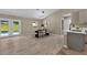 An open-concept dining room boasts modern lighting and views of the pool and backyard at 10545 Parkway Dr, Clermont, FL 34711