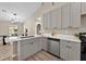 Modern kitchen with stainless steel appliances, white countertops, gray cabinets, and an island at 10545 Parkway Dr, Clermont, FL 34711