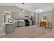 Modern kitchen boasts gray cabinets, stainless steel appliances, and an adjacent dining area at 10545 Parkway Dr, Clermont, FL 34711