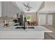 Modern kitchen island with stainless steel appliances and a view of the dining area at 10545 Parkway Dr, Clermont, FL 34711
