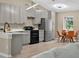 Bright kitchen features gray cabinets, modern appliances, and a dining area at 10545 Parkway Dr, Clermont, FL 34711