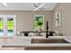 Bright and modern kitchen island featuring an undermount sink and a stylish faucet with dining area view at 10545 Parkway Dr, Clermont, FL 34711