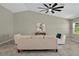 Bright living room featuring a ceiling fan, modern decor, and neutral color palette at 10545 Parkway Dr, Clermont, FL 34711