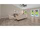 Spacious living room with tile floors, modern decor, and sliding doors to the pool area at 10545 Parkway Dr, Clermont, FL 34711