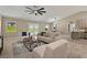 Open living area featuring tile floors, neutral walls, ceiling fan, and outdoor views at 10545 Parkway Dr, Clermont, FL 34711