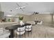Open-concept living and dining area with tile flooring, contemporary lighting, and comfortable seating arrangement at 10545 Parkway Dr, Clermont, FL 34711