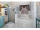 Well-lit bathroom featuring a tub and separate shower, with tiled floors at 11900 Frieth Dr, Orlando, FL 32837