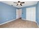 Neutral bedroom with tile floors, a ceiling fan, and double door closet at 11900 Frieth Dr, Orlando, FL 32837