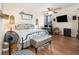 Comfortable bedroom with hardwood floors, ceiling fan, and ample natural light at 11900 Frieth Dr, Orlando, FL 32837
