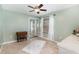 Green bedroom with carpet, ceiling fan, and mirrored sliding door closet at 11900 Frieth Dr, Orlando, FL 32837