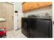 Functional laundry room with modern appliances and tiled floors at 11900 Frieth Dr, Orlando, FL 32837