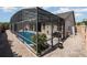 Enclosed pool area with foliage, grill, and patio seating at 11900 Frieth Dr, Orlando, FL 32837