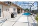 Enclosed pool area with grill and plenty of seating at 11900 Frieth Dr, Orlando, FL 32837