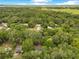 Beautiful aerial view of a home nestled among lush, green trees in a rural setting at 12046 Se 135Th Ave, Ocklawaha, FL 32179