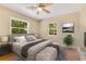 Comfortable bedroom with soft lighting, large windows, and a well-appointed bed at 12046 Se 135Th Ave, Ocklawaha, FL 32179