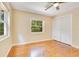 Bedroom features hardwood floors, two windows, a ceiling fan and a closet with louvered doors at 12046 Se 135Th Ave, Ocklawaha, FL 32179