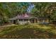 Charming single-story home with a well-maintained lawn, mature trees, and a convenient carport at 12046 Se 135Th Ave, Ocklawaha, FL 32179