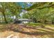 Inviting single-story home with mature trees, a well-kept lawn, and a convenient carport at 12046 Se 135Th Ave, Ocklawaha, FL 32179