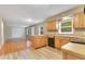 Functional kitchen featuring wooden cabinets, a black appliance suite, and an island at 12046 Se 135Th Ave, Ocklawaha, FL 32179
