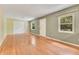 Bright living room with hardwood floors, natural light, and large windows at 12046 Se 135Th Ave, Ocklawaha, FL 32179