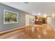 Open-concept living room with hardwood floors and a clear view of the kitchen at 12046 Se 135Th Ave, Ocklawaha, FL 32179