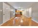 Spacious living room with hardwood floors leading into the kitchen area at 12046 Se 135Th Ave, Ocklawaha, FL 32179