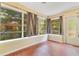 Bright sunroom features large windows offering views of lush greenery at 12046 Se 135Th Ave, Ocklawaha, FL 32179