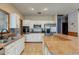 Bright kitchen with white cabinets, stainless steel appliances, breakfast bar, and a functional design at 13 Bass Lake Dr, Debary, FL 32713
