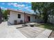 Well-maintained backyard with patio seating, exterior building, and mature landscaping at 1505 Magnolia Ave, Sanford, FL 32771