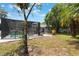 Landscaped backyard featuring a pool with screened enclosure, patio furniture and a barbecue grill at 1505 Magnolia Ave, Sanford, FL 32771