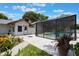 Charming backyard with screened-in pool and white home exterior at 1505 Magnolia Ave, Sanford, FL 32771